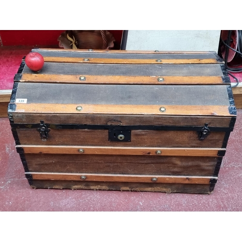 339 - A large early 20th century travel trunk with wooden, brass and canvas elements. With a removable she... 