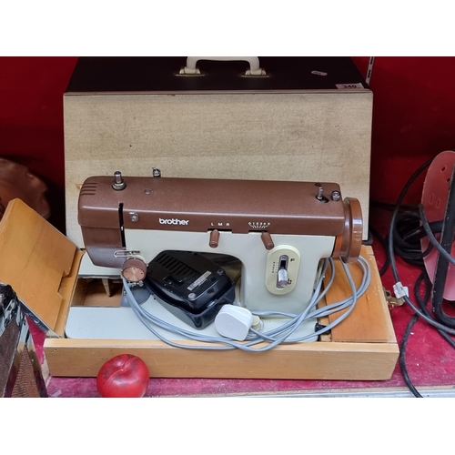 340 - A c. 1970s Brother sewing machine model E no. 111667. Held in an original carry case and accompanied... 