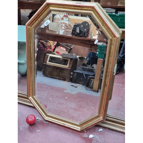 356 - A large elegant bevelled wall mirror held in a gilt wooden frame.