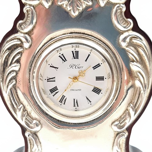 476 - A sterling silver mantel clock by the acclaimed Carrs of Sheffield, featuring a French profuse style... 