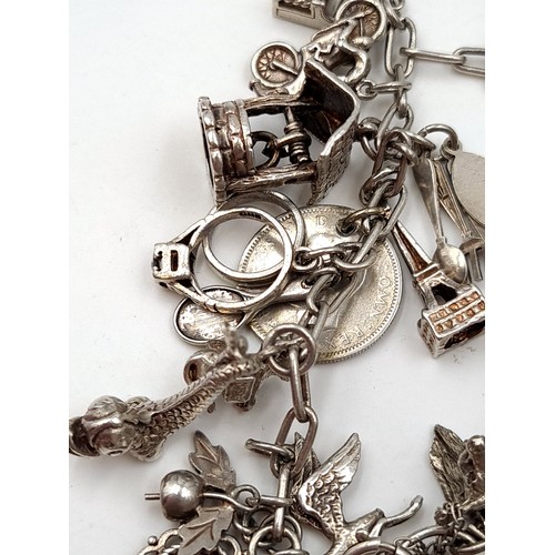 481 - A stunning, high quality multi charm sterling silver bracelet. Set with high quality charms and a we... 