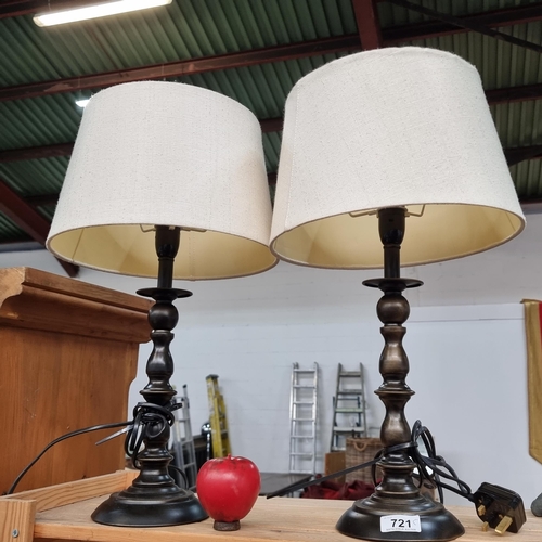 721 - Two stylish table lamps with nice turned stems topped with cream shades fitted with three pronged pl... 