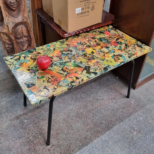 722 - A super cool coffee table featuring colourful comic book cutouts to top.