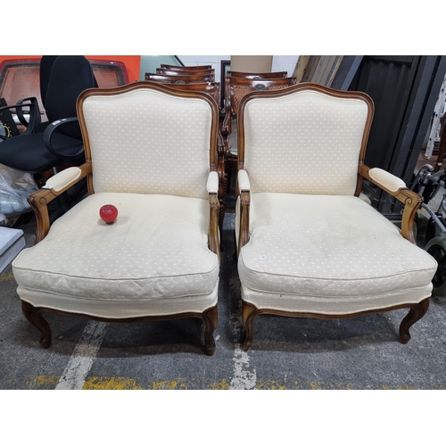 776 - Star Lot : A pair of elegant oversized  French style armchairs from Grange. With wide backrests and ... 