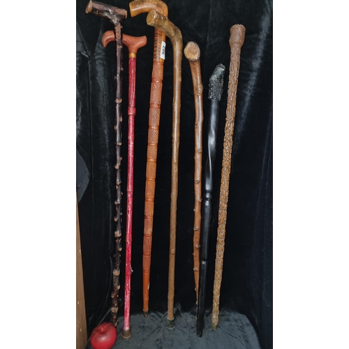 902 - A selection of 7 unusual walking sticks including one featuring a handle with two faces , black thor... 