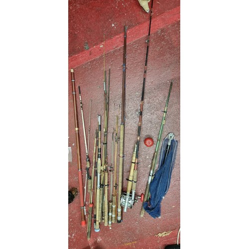 264 - A large selection of fishing equipment including both fly and sea fishing rods as well as a large re... 