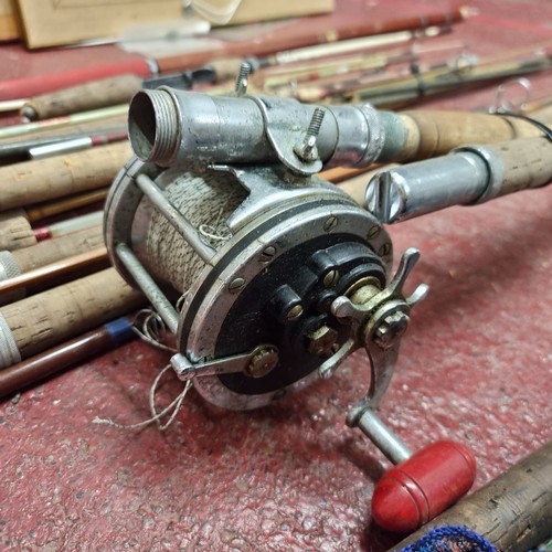 264 - A large selection of fishing equipment including both fly and sea fishing rods as well as a large re... 