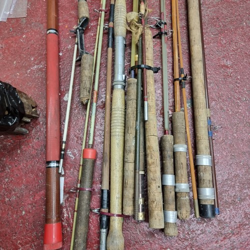 264 - A large selection of fishing equipment including both fly and sea fishing rods as well as a large re... 