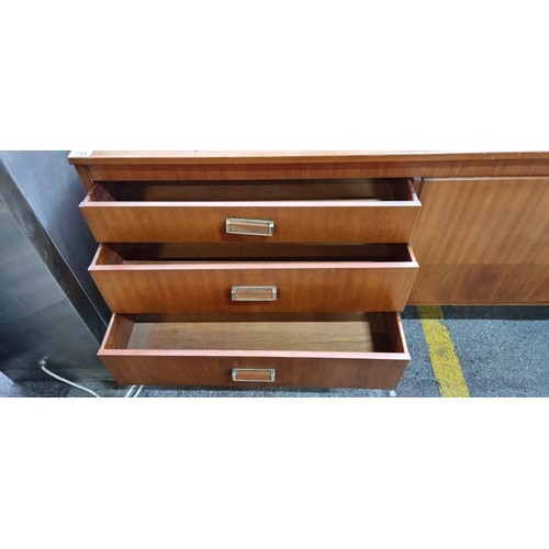 714 - A fabulous and super stylish Midcentury teak sideboard with three drawers, two cupboard door with si... 