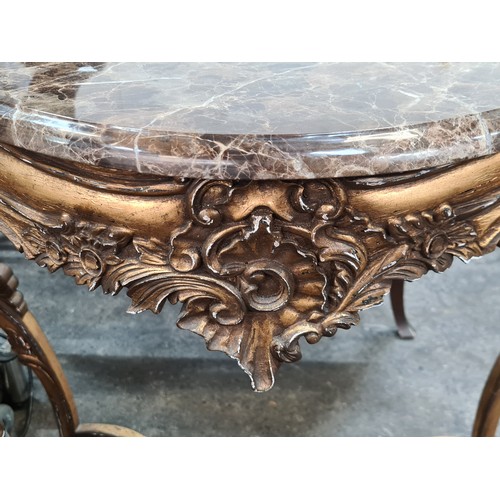 768 - Star lot : A very elaborate console table with a brown marble top held on a profusely carved gilt wo... 