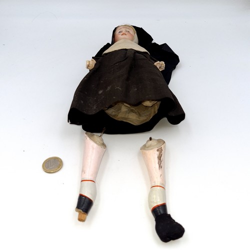 406 - A vintage 1930's porcelain doll, in the form of a nun. Set with original material garnets, hand pain... 