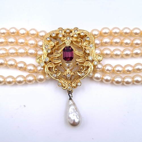 420 - A Gothic style five strand pearl necklace, set with a central Amethyst central stone and flanked by ... 