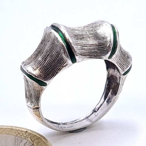 423 - A highly unusual polished silver ring, set with flayed accents and green detail. Ring size: O. Weigh... 