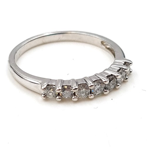 486 - Star Lot : A sparkling example of a seven stone bright Diamond half eternity ring, of .33 carats of ... 