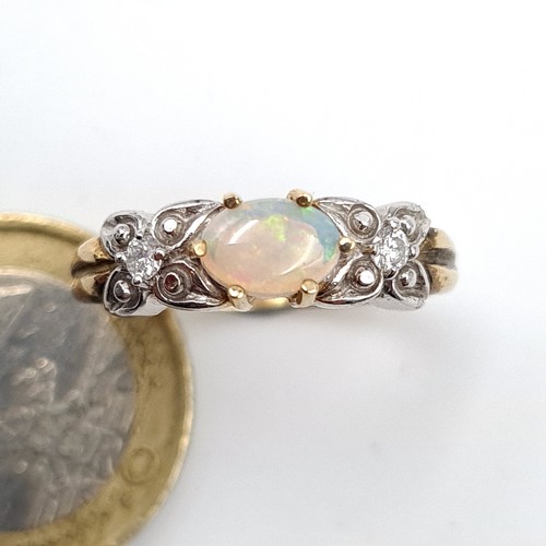 488 - Star Lot : A very fine example of a vintage 9 carat gold Diamond and Opal three stone ring, set in a... 