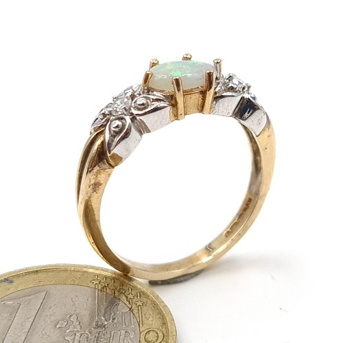 488 - Star Lot : A very fine example of a vintage 9 carat gold Diamond and Opal three stone ring, set in a... 