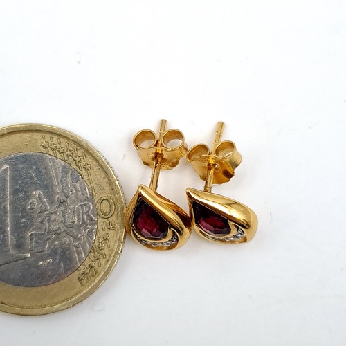 492 - A pair of striking gold plated Garnet stone and White Sapphire tear drop stud earrings. Old, new sto... 