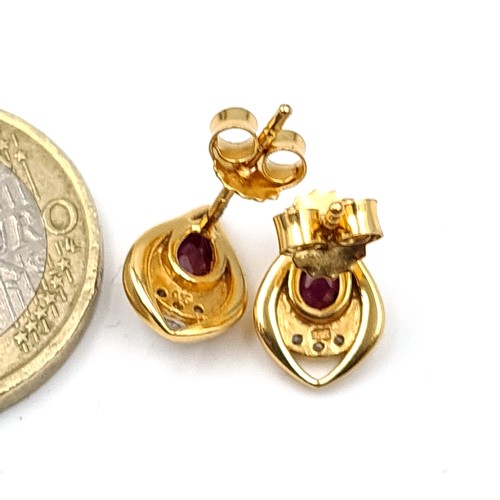 492 - A pair of striking gold plated Garnet stone and White Sapphire tear drop stud earrings. Old, new sto... 