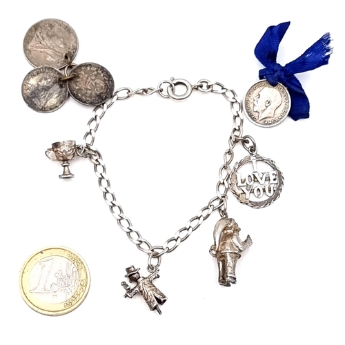 An antique  sterling silver 5 charm Bracelet together with 3 Queen Victoria Coins and a George V coin. Total weight 21.4 gms.