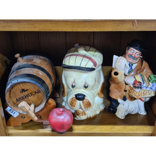 851 - Three charming items including a 'Delivery Man' teapot, a dog themed biscuit barrel and wooden wine ... 