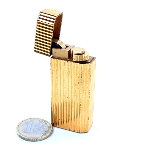 13 - Star Lot : A must de Cartier gas lighter with channel cut finish to body. No.A72814