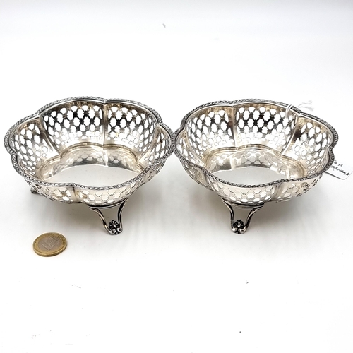 23 - A collection of 2 scalloped edged sterling silver bonbon dishes, each standing on 3 shell designed f... 