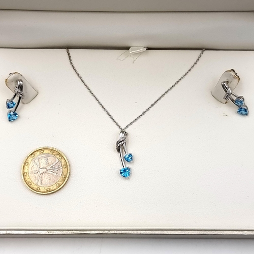 60 - Star Lot : A most attractive suite of Jewellery consisting of a White Gold Topaz and Diamond Pendant... 