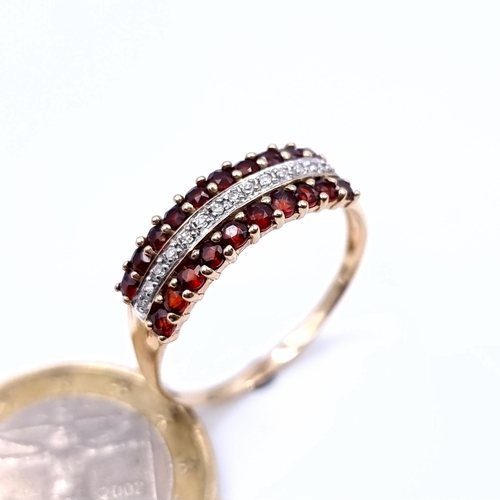 887 - Star Lot : A mesmerising example of a 9 carat gold Diamond and Garnet half eternity ring, this fabul... 