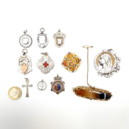 954 - A selection of items including Medals, Brooches and Pendants including a sterling silver cross of Lo... 