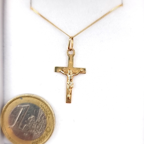 960 - An elegant 9ct Gold Necklace with a crucifix pendant. Both featuring 375 hallmarks. With presentatio... 