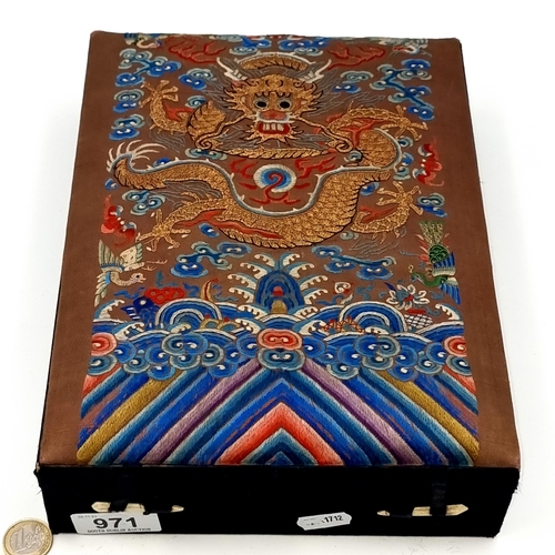 971 - A superb embroidered jewelry box depicting a Chinese dragon to top, opening to reveal six separate c... 