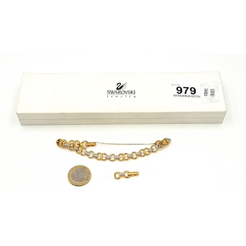 979 - A dazzling Swarovski Crystal gold toned link bracelet with safety chain. Accompanied by an extra lin... 