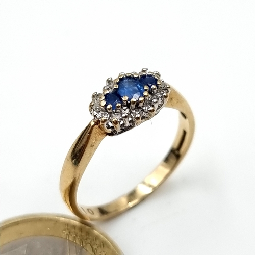 982 - Star Lot : A very pretty 3 stone Sapphire Ring with Diamond surround, Ring size N, weight 2 gms.