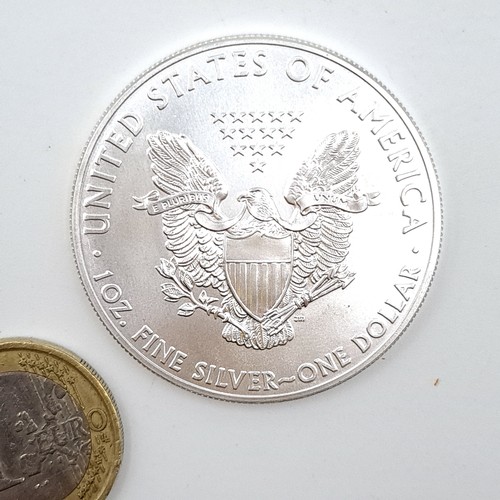 14 - An excellent uncirculated United States of America one ounce fine silver one dollar coin. Weight 31.... 