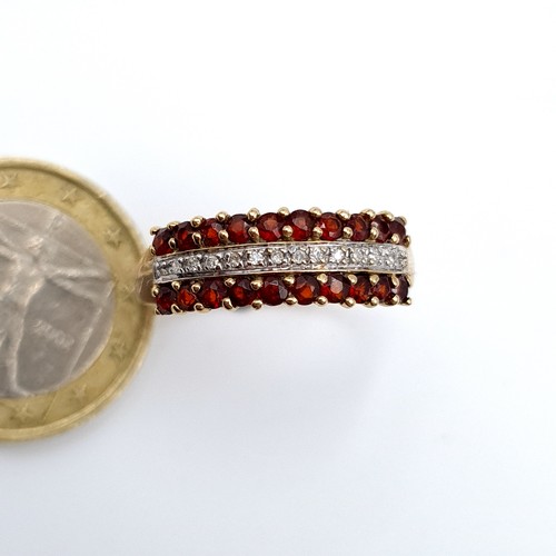 887 - Star Lot : A mesmerising example of a 9 carat gold Diamond and Garnet half eternity ring, this fabul... 