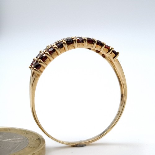 887 - Star Lot : A mesmerising example of a 9 carat gold Diamond and Garnet half eternity ring, this fabul... 