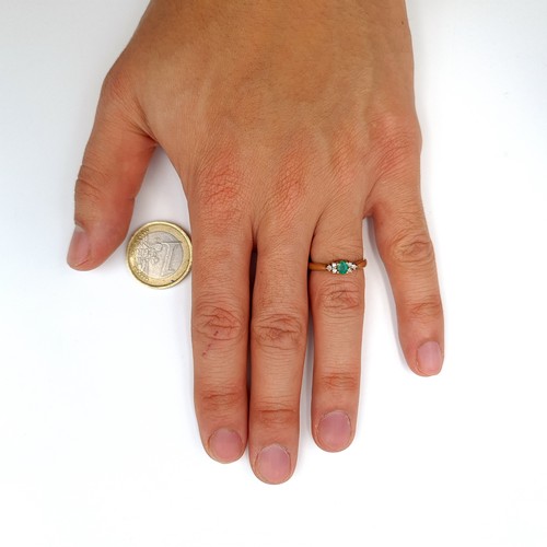 888 - Star Lot : A fabulous example of a vintage Emerald and Diamond 9 carat gold ring, this example featu... 