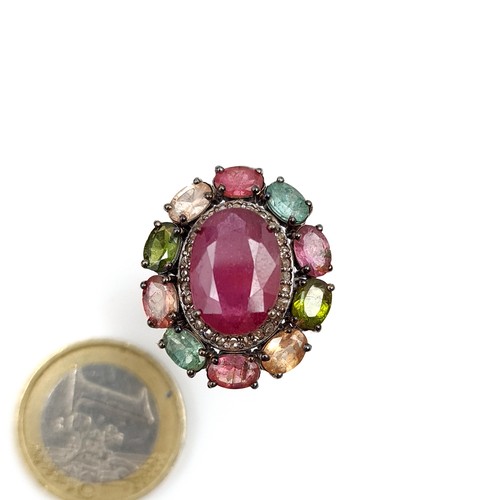 916 - Star Lot : A fabulous large natural Ruby Ring of 5carats with a multi stone surround of Topaz, tourm... 