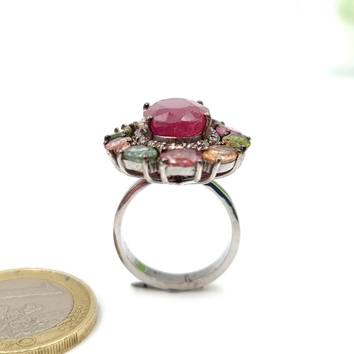 916 - Star Lot : A fabulous large natural Ruby Ring of 5carats with a multi stone surround of Topaz, tourm... 