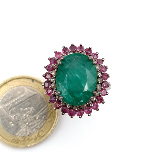 919 - Star Lot : A Beautiful natural  Emerald stone Ring of 6.35 cts with a Ruby and Diamond surround moun... 