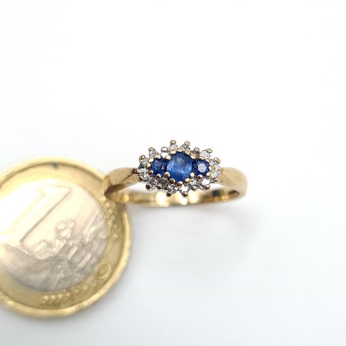 982 - Star Lot : A very pretty 3 stone Sapphire Ring with Diamond surround, Ring size N, weight 2 gms.