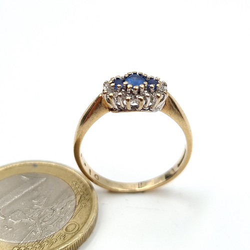 982 - Star Lot : A very pretty 3 stone Sapphire Ring with Diamond surround, Ring size N, weight 2 gms.