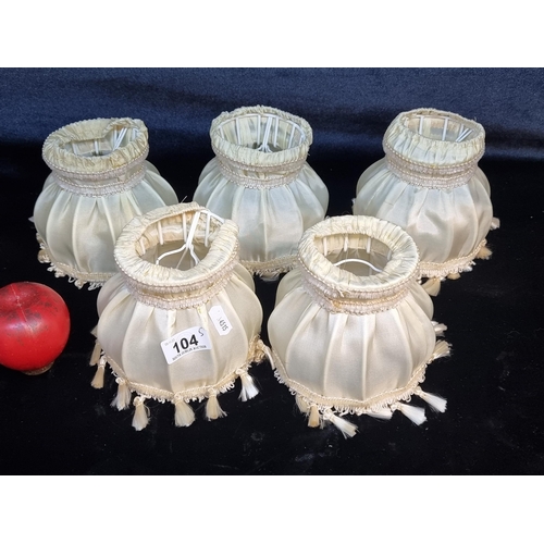 104 - A set of five elegant neatly sized lamp shades with a tassle trim. In a champagne shade. These just ... 