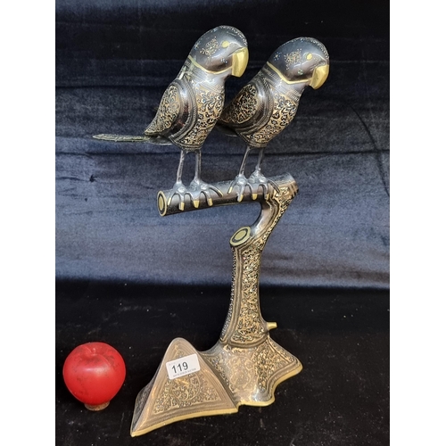 119 - An unusual large brass figure of parrots seating on a branch.  Featuring elaborate decoration with g... 