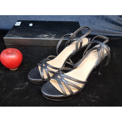 153 - A lovely pair of brand new genuine leather Guess high heel sandal shoes with black leather straps. S... 