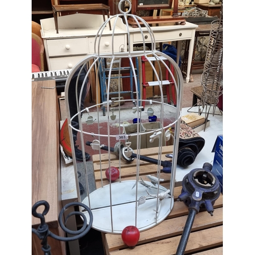 303 - An unusual Victorian style metal decorative bird cage, set with a mirrored back and wall mounting fe... 