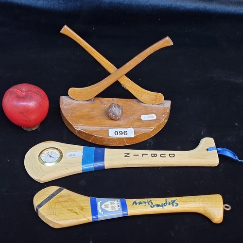 96 - Three hurling themed wooden items including a desktop sculpture with hurls and sliotar. Along with t... 