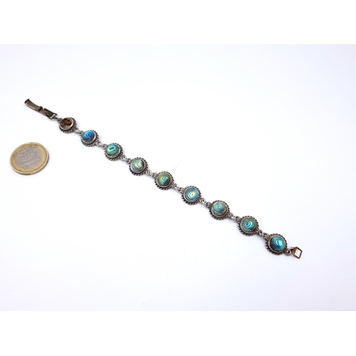 803 - A pretty Abalone Shell sterling silver Bracelet, total weight 18gms, (1 stone missing).