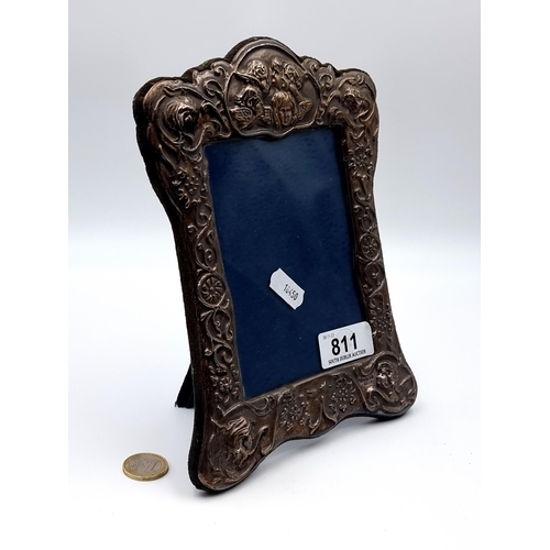 811 - An attractive Sterling Silver Glazed Photo Frame with cherub and swag detailing to Frame, hallmarked... 