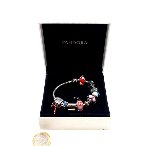 814 - A beautiful original Pandora Charm Bracelet, set with 10 charms, weight 54.53gms, contained in origi... 